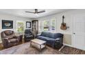 Cozy living room featuring hardwood floors, a ceiling fan, and large windows, offering natural light at 2631 Ridgewood Ave, Charleston, SC 29414