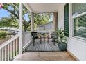 Inviting porch featuring a stylish rug, comfortable seating, and lush potted plants, perfect for relaxation at 2666 Poplin Ave, North Charleston, SC 29405
