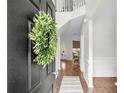 Welcoming foyer view showcasing the staircase and seamlessly flowing into the kitchen and dining area at 2727 Four Winds Pl, Mount Pleasant, SC 29466