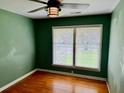 Bedroom with hardwood floors, ceiling fan, and natural light from the large window at 2734 Mona Ave, Charleston, SC 29414