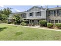 Charming two-story brick townhouse with a well-manicured lawn and lush landscaping at 2906 Cathedral Ln, Charleston, SC 29414