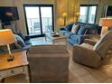 Cozy living room with comfortable seating and large windows boasting natural light at 311 Seascape (Share G), Isle of Palms, SC 29451