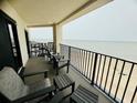 Relaxing balcony with comfortable seating overlooking the ocean and a sandy beach at 311 Seascape (Share H), Isle of Palms, SC 29451