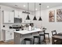 Modern kitchen with white cabinets, a center island, and stainless steel appliances at 328 Surfbird Rd, Summerville, SC 29486