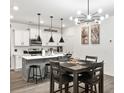 Open kitchen and dining room with modern lighting and stainless steel appliances at 328 Surfbird Rd, Summerville, SC 29486