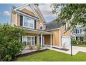 The charming exterior of this home features a well manicured lawn and a cozy front porch with rocking chair at 3807 Canary Ct, North Charleston, SC 29420
