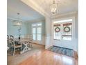 Bright foyer and dining area showcasing hardwood floors, modern lighting, and stylish decor at 401 Felders Ln, Johns Island, SC 29455