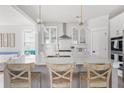 Modern kitchen with white cabinets, an island with seating, and stainless steel appliances at 428 Bluegill Ln, Johns Island, SC 29455
