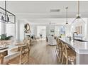 Bright, open-concept living space with modern lighting, a fireplace and views to the kitchen at 428 Bluegill Ln, Johns Island, SC 29455