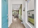 Inviting foyer showcasing wood floors and a glimpse into the brightly lit living room with green accents at 513 Sea Foam St, Summerville, SC 29486