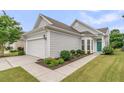 A well-maintained home featuring an attached garage, tidy landscaping, and a welcoming front entrance at 513 Sea Foam St, Summerville, SC 29486