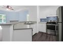 Well-equipped kitchen featuring stainless steel appliances, white cabinets, and a breakfast bar overlooking the living area at 60 Fenwick Hall Allee # 738, Johns Island, SC 29455