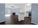 Inviting living space featuring a fireplace, ceiling fan, wood floors and an open kitchen with stainless appliances at 60 Fenwick Hall Allee # 738, Johns Island, SC 29455
