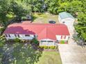 Aerial view of a well-maintained home with a red roof, detached garage, and spacious backyard at 617 Deepwood Ct, Moncks Corner, SC 29461