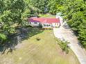 An aerial shot of a charming home featuring a red roof, well-kept lawn, and convenient driveway at 617 Deepwood Ct, Moncks Corner, SC 29461