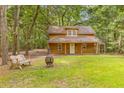 Quaint one-story home with a covered front porch, perfect for enjoying the serene surroundings at 6464 Saint Anthony Dr, Meggett, SC 29449