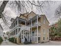 Rear exterior of a multi-story home with multiple balconies, offering outdoor living spaces at 65 Vanderhorst St # C, Charleston, SC 29403