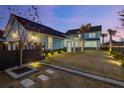 The backyard features lush green grass, tasteful landscaping, string lights, and a cozy screened-in porch at 711 Blueway Ave, Summerville, SC 29486