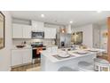 Modern kitchen featuring white cabinets, stainless steel appliances, and a stylish center island with seating at 8030 Rackham Rd, Hollywood, SC 29470
