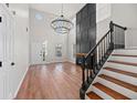 Bright living room features high ceilings, a modern fireplace, and sleek hardwood floors at 8340 Coventry Ct, North Charleston, SC 29420