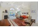 Comfortable living room featuring a fireplace, vaulted ceilings and seamless transition to the sunroom at 103 Ashley Villa Cir # D, Charleston, SC 29414