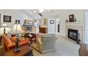 Spacious living room with fireplace, plush seating, and seamless flow into the adjacent kitchen at 103 Ashley Villa Cir # D, Charleston, SC 29414