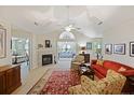 Bright living room with fireplace, vaulted ceilings, and open layout flowing into sunroom and bedroom at 103 Ashley Villa Cir # D, Charleston, SC 29414