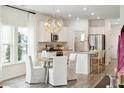 Eat-in kitchen features white cabinets, stainless appliances and a modern pendant light at 1044 Scotch Bonnet Way, Summerville, SC 29485