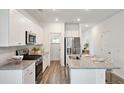 Bright kitchen with white cabinets, stainless steel appliances, and granite countertops at 1044 Scotch Bonnet Way, Summerville, SC 29485