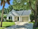Inviting single story home featuring an attached garage, well kept lawn, and a freshly sealed driveway at 108 Alston Cir, Goose Creek, SC 29445