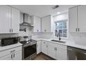 Bright kitchen with white cabinets, stainless steel appliances, and subway tile backsplash at 1105 Crull Dr, Charleston, SC 29407