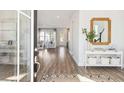 Inviting foyer showcasing wood floors, stylish console table and a mirror to brighten the space at 111 Battle Boat Blvd, Summerville, SC 29485
