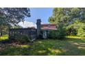 Exterior view shows home with a chimney and enclosed sunroom, set against lush greenery at 116 Stillfield Dr, Moncks Corner, SC 29461