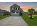 Beautiful two-story home featuring an extended driveway and a vibrant green lawn at 118 Lagoona Dr, Summerville, SC 29483