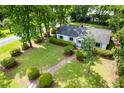 Lovely aerial view showcasing a well-maintained yard, beautiful landscaping, and mature trees at 1203 Forestwood Dr, Charleston, SC 29407