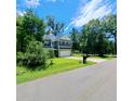 Well-maintained two-story home with attached garage, green lawn, and mature trees at 133 Pelican Lane, Summerville, SC 29485