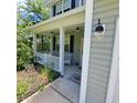 Inviting front porch with white railing, overhead lighting, and decorative details at 133 Pelican Lane, Summerville, SC 29485