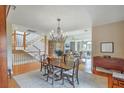 Open dining room with wood table, chandelier, and views to the staircase and living room at 1343 Headquarters Plantation Dr, Johns Island, SC 29455