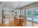 Eat in kitchen with white cabinets, granite counters, stainless appliances, hardwood floors and backyard access at 1343 Headquarters Plantation Dr, Johns Island, SC 29455
