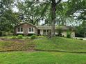 Traditional brick home nestled on a lush lawn with mature trees, exuding charm and curb appeal at 1389 Parkshore Dr, Charleston, SC 29407