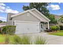 Charming home with gray siding, black accents, and a spacious two-car garage at 1460 Oldenburg Dr, Mount Pleasant, SC 29429