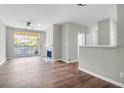 Open living room features a fireplace, wood floors, neutral paint, and a sliding door leading to a balcony at 1600 Long Grove Dr # 423, Mount Pleasant, SC 29464