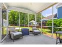 Relaxing screened-in porch with comfortable seating and views of the backyard and lush landscaping at 1666 Sparkleberry Ln, Johns Island, SC 29455