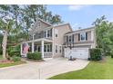 Two-story home features a spacious driveway with a basketball hoop and a well-manicured lawn at 1728 Wellstead St, Mount Pleasant, SC 29466
