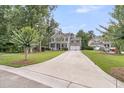 View of a beautiful, two-story home with a long driveway, front porch, and well-maintained lawn at 1728 Wellstead St, Mount Pleasant, SC 29466