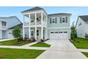 Charming two-story home with inviting front porch, balcony, and manicured lawn at 198 Steepbrook Dr, Summerville, SC 29486