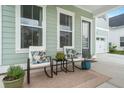 Inviting front porch with chairs and a table perfect for relaxation at 198 Steepbrook Dr, Summerville, SC 29486