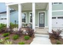 Inviting front porch with chairs and a table for relaxing at 198 Steepbrook Dr, Summerville, SC 29486