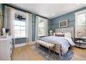 Bright bedroom with large windows, neutral tones, paneled accent wall, and stylish decor at 2026 Sea Water Dr, Charleston, SC 29412