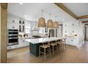 Bright, open kitchen with a large center island, white cabinets, and pendant lighting at 2026 Sea Water Dr, Charleston, SC 29412